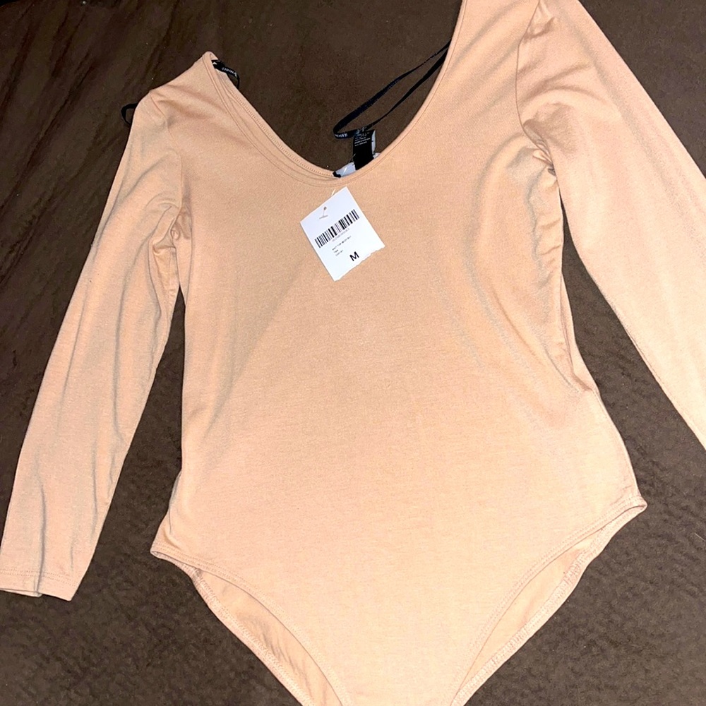 Creamish / nude colored body suit  long sleeve top.